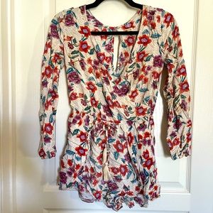 Gorgeous floral romper! Love the fringe adjustable waist bands.